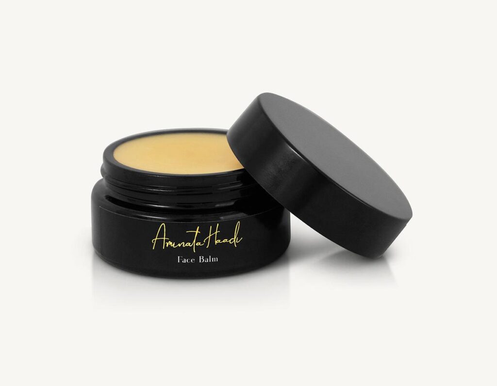Luxurious face balm by Aminata Haadi, elegantly packaged, showcasing its rich texture and nourishing properties.