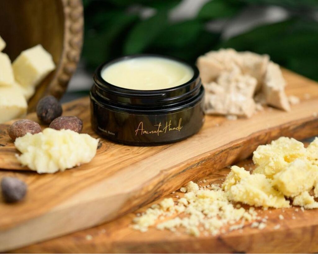 Raw shea butter body butter on a wooden display with mango butter, cocoa butter, and kokum butter.