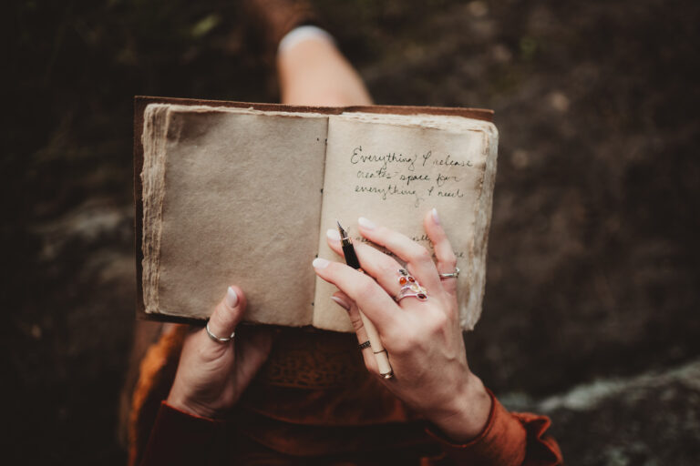Woman writing a journal entry for daily reflection.
