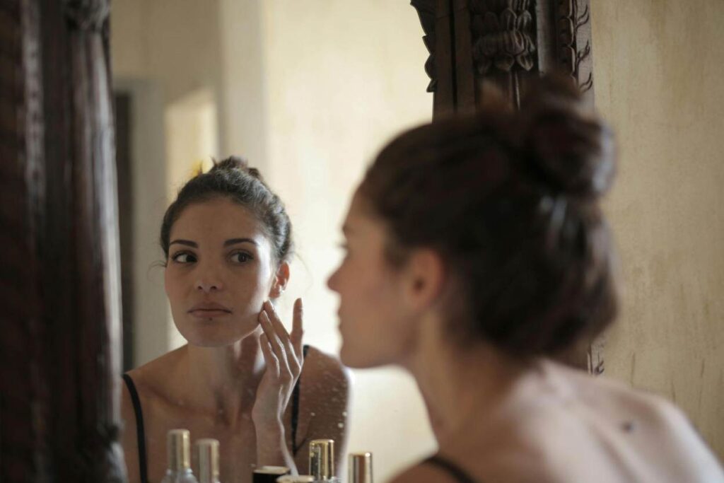 Woman applying raw shea butter face balm