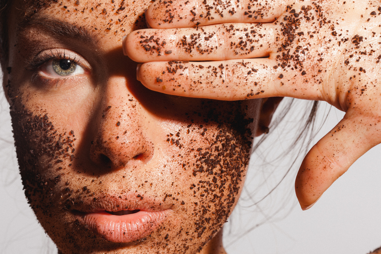 Woman with exfoliating scrub on face.