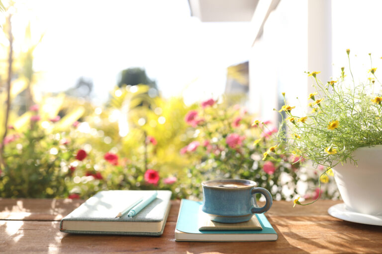 Beautiful plants adorn writing space for a journal entry of morning inspirational quotes.