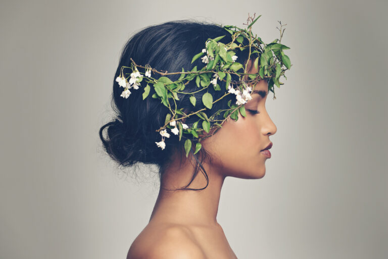 Woman wearing floral crown for conscious beauty headshot.