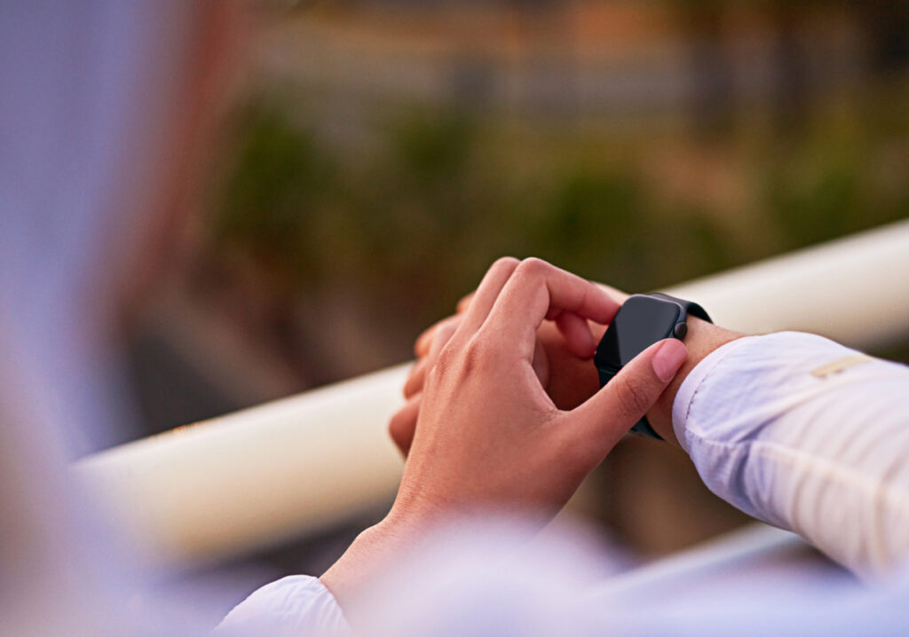 Person checking fitness tracker. 